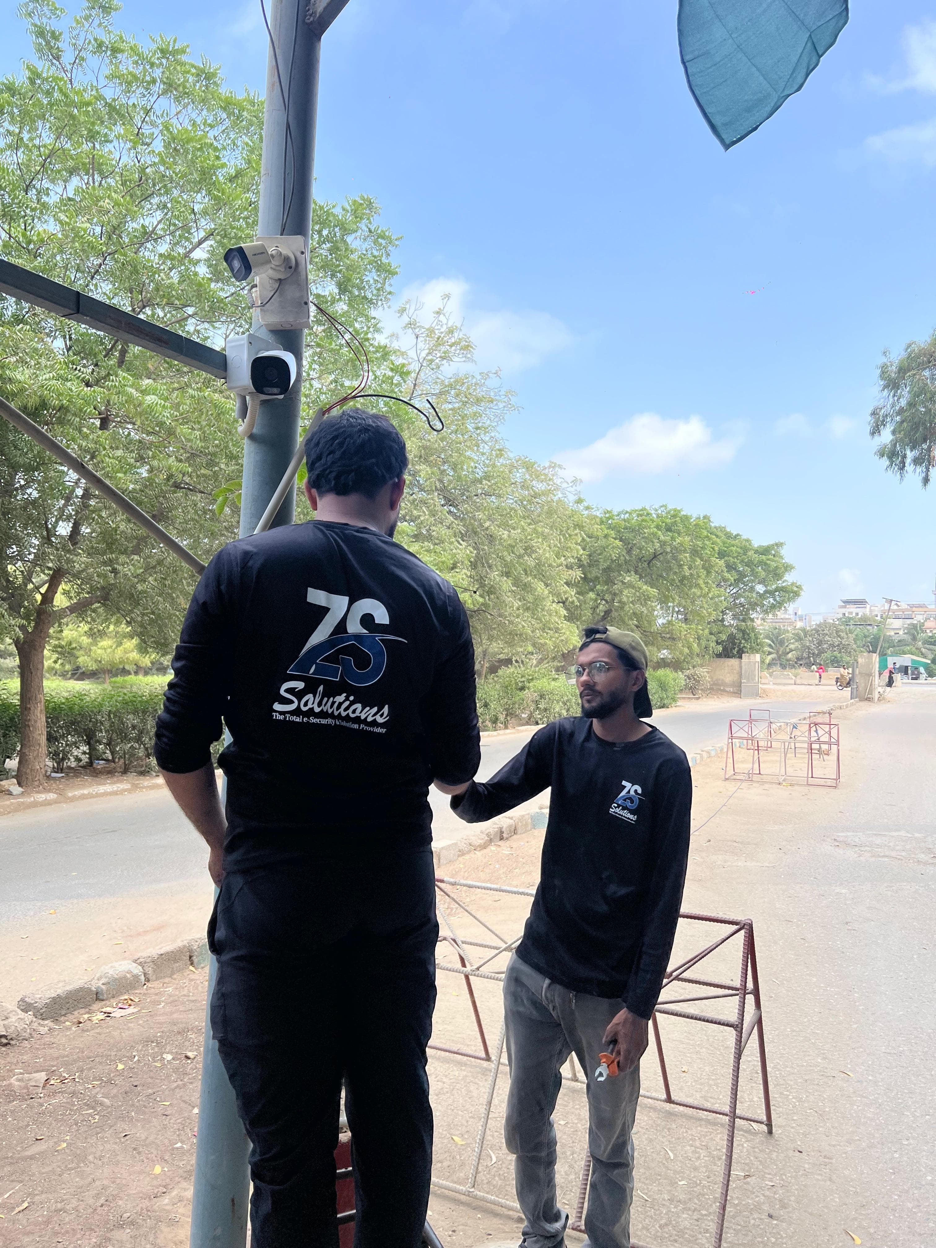 ZS Solutions field engineers installing outdoor security cameras